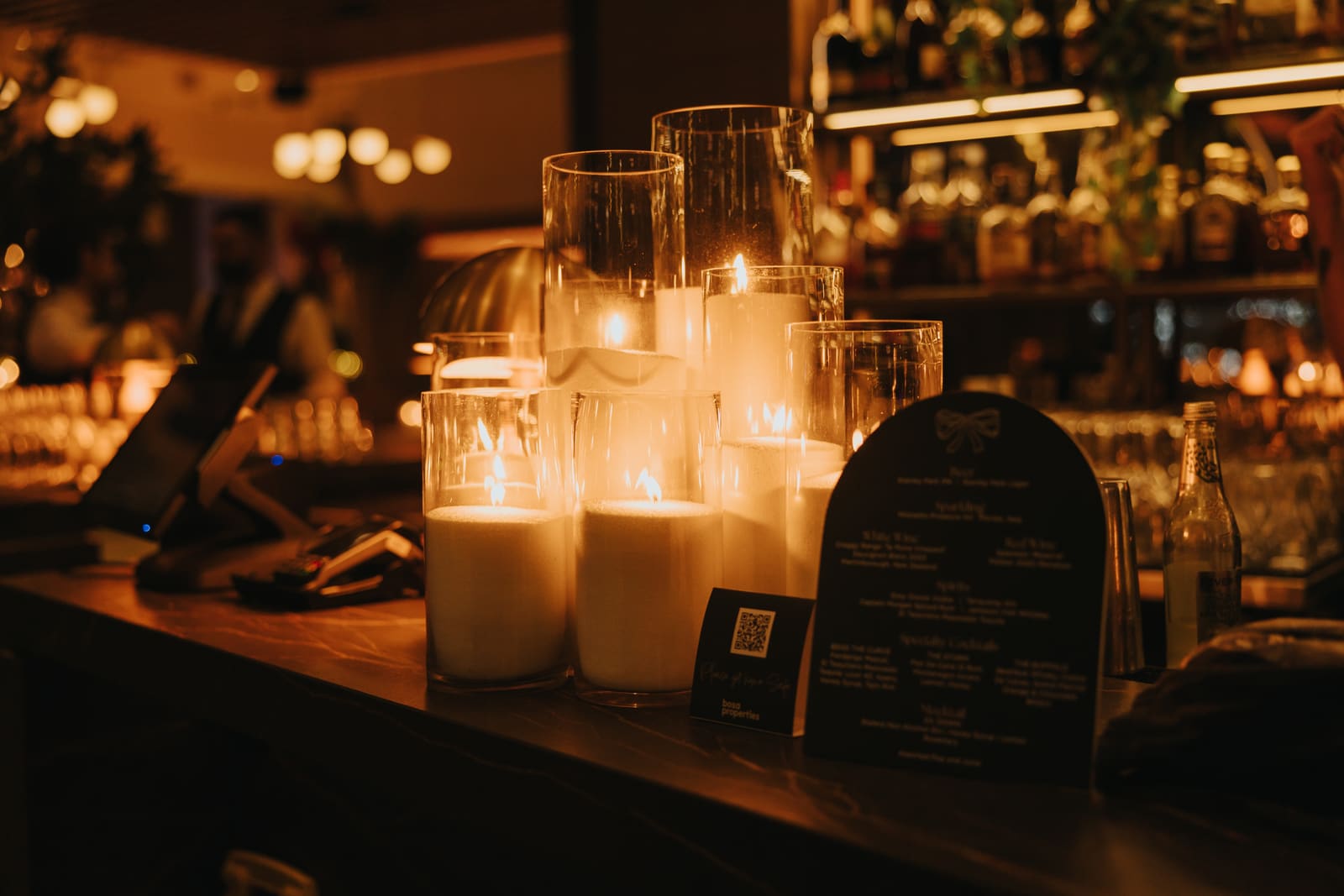 A candlelit bar setup at a Riley’s event